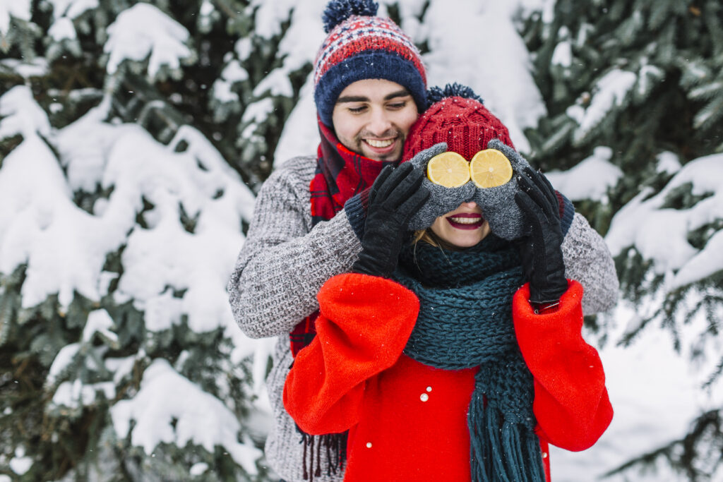 playful-man-with-girlfriend-winter-woods